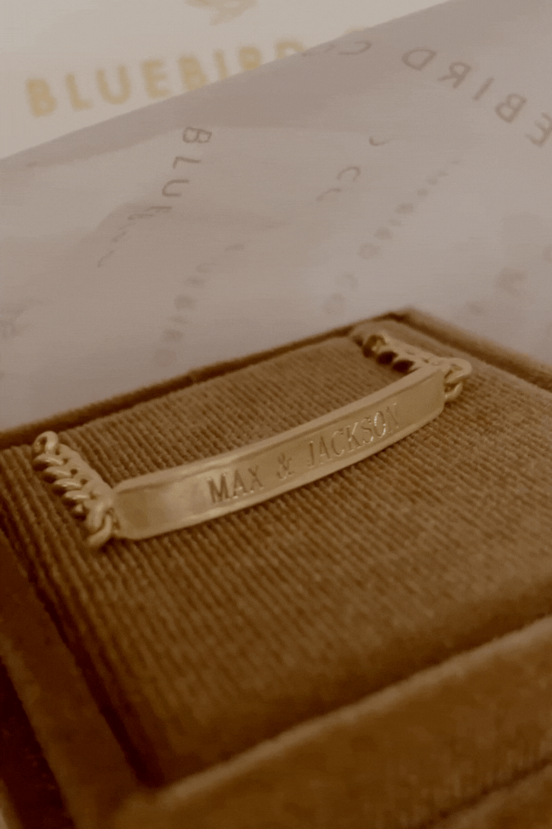 Bluebird Co's signature bracelet in gold placed in velvet box.