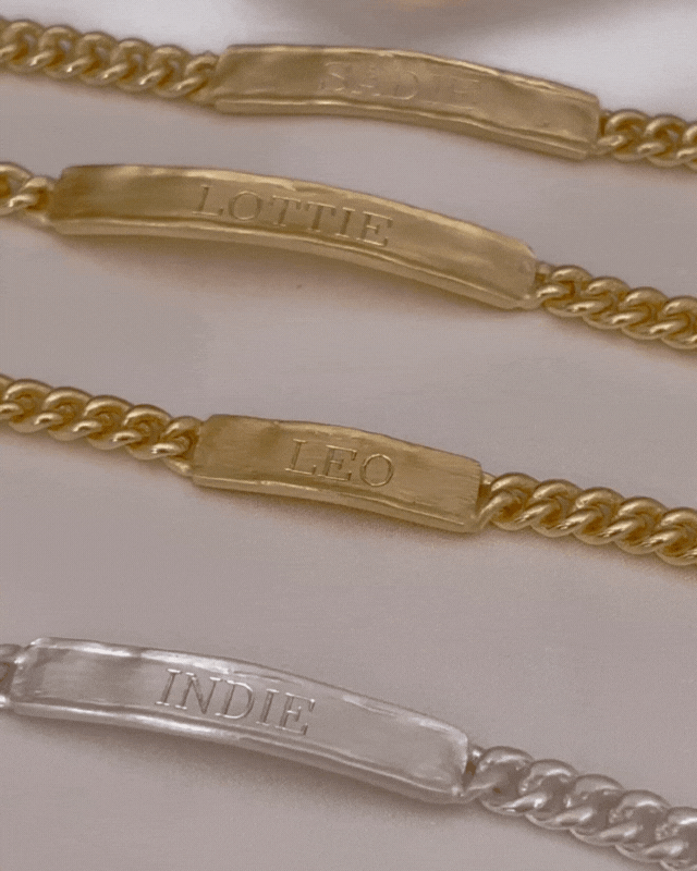 Bluebird Co signature bracelets outlay displaying the signature bracelets in gold and silver and signature pendant.