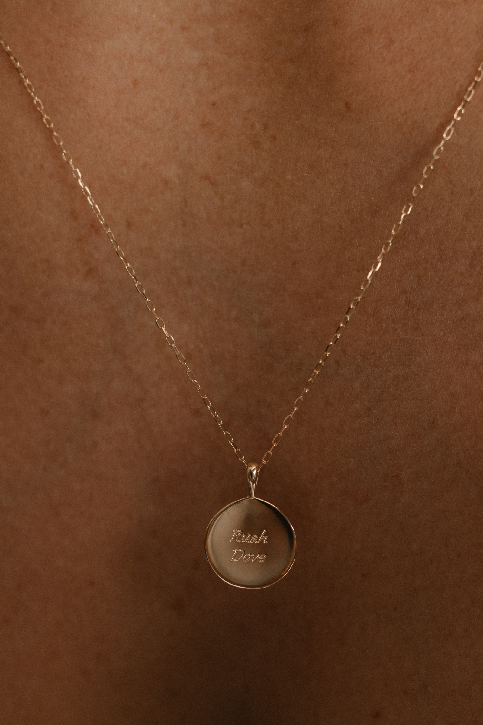 A close-up image of the Soléil Pendant – 9ct Gold with chain, featuring a radiant round design and complimentary engraving on both sides for a truly personal touch.