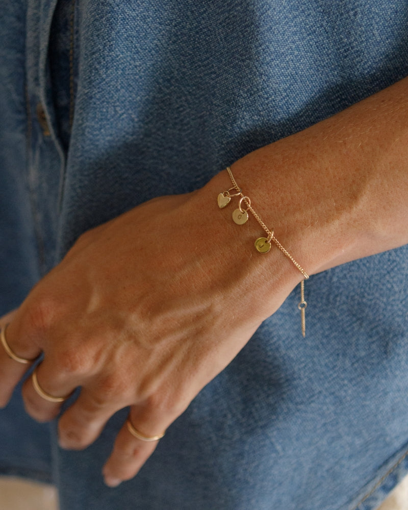 The Bluebird Jewellery Solid Gold Bracelet with initial pendants, a refined and timeless personalised gold bracelet that pairs effortlessly with any occasion.