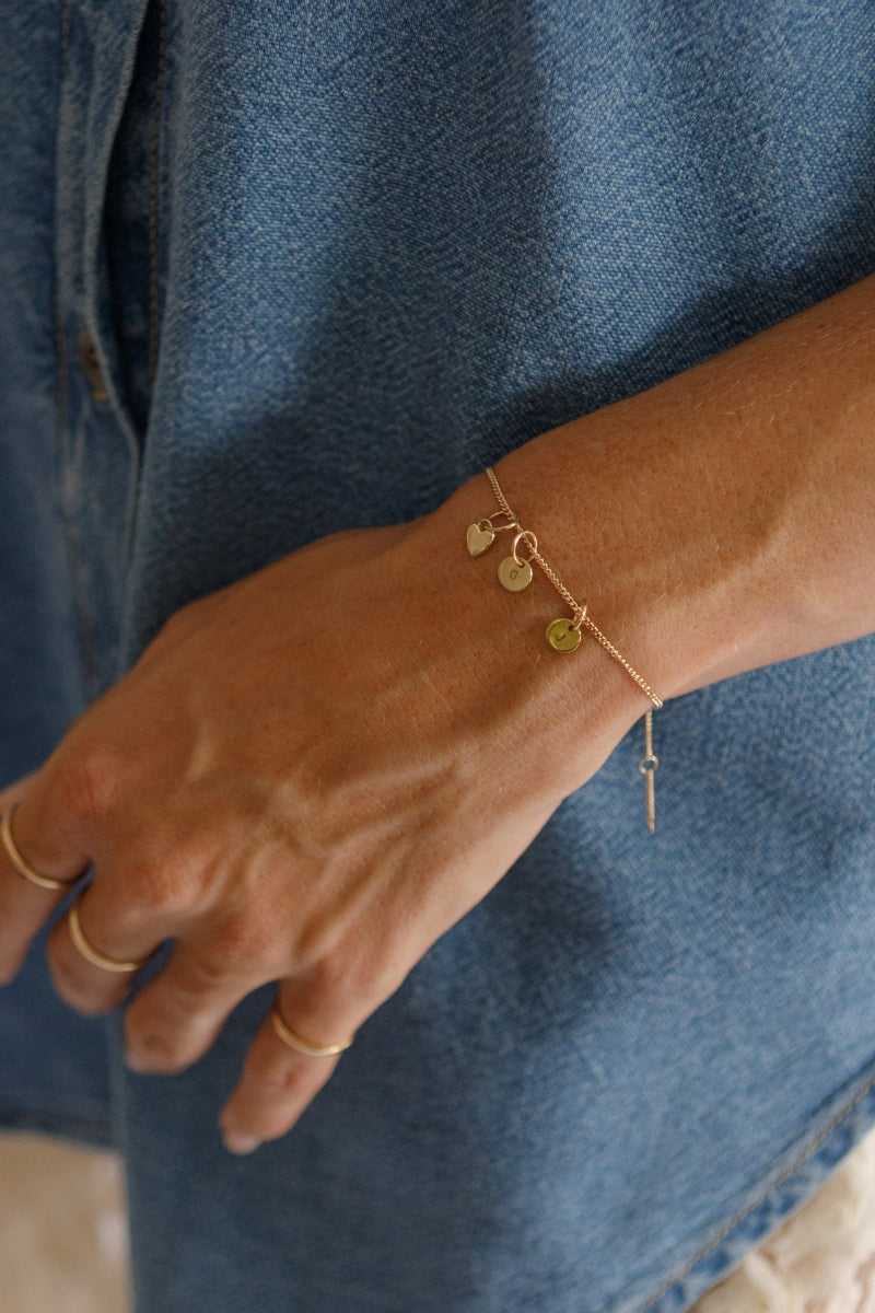 The Bluebird Jewellery Solid Gold Bracelet with initial pendants, a refined and timeless personalised gold bracelet that pairs effortlessly with any occasion.