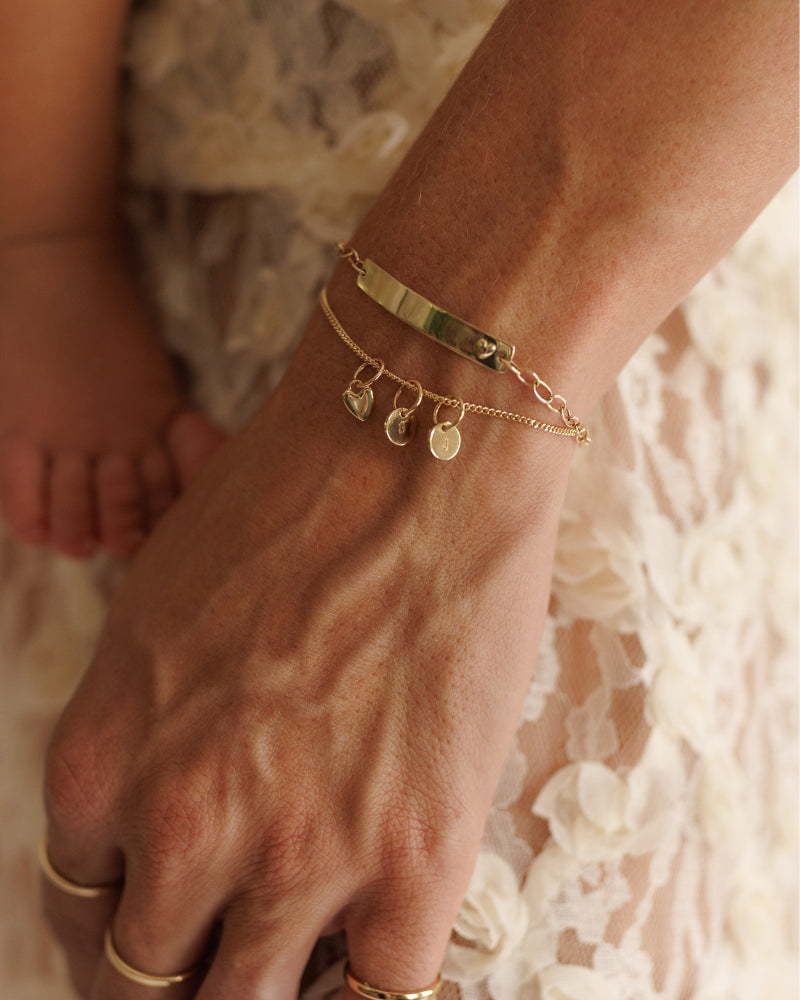 The Bluebird Jewellery Solid Gold Bracelet with pink darling bracelet and initial pendants, a refined and timeless personalised gold bracelet that pairs effortlessly with any occasion.