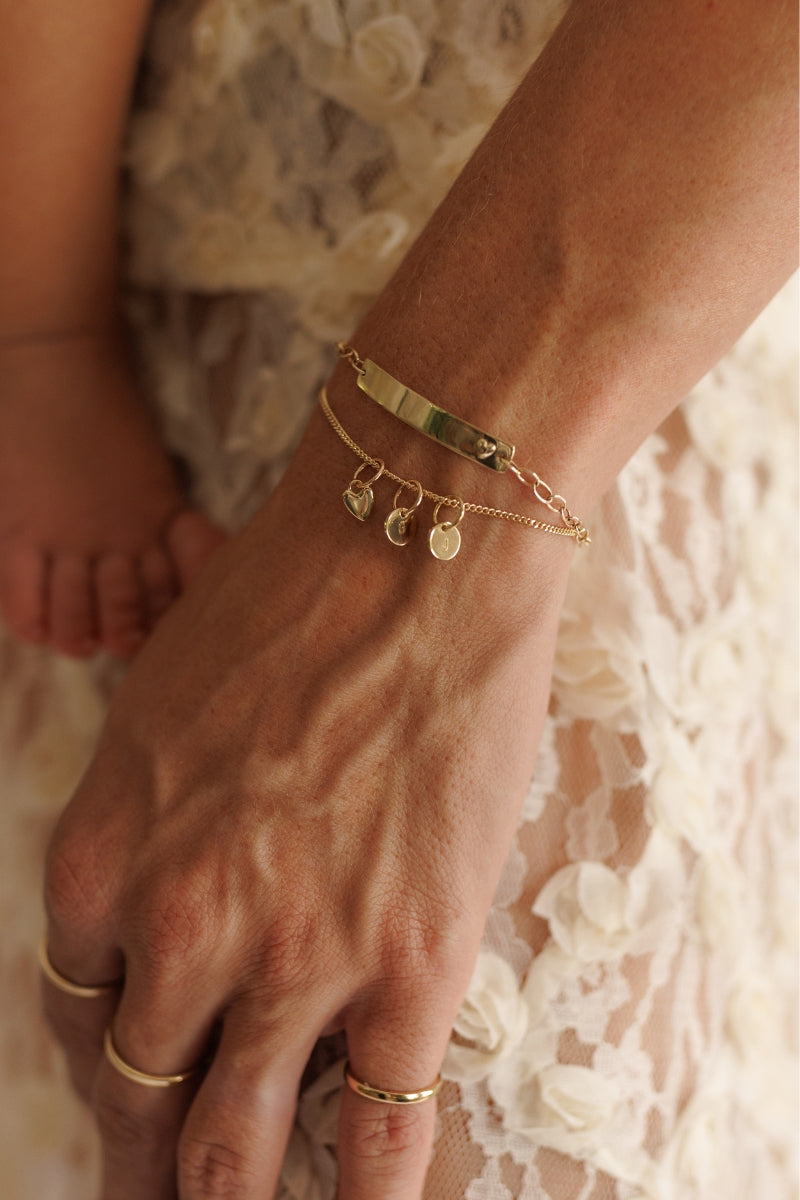 The Bluebird Jewellery Solid Gold Bracelet with pink darling bracelet and initial pendants, a refined and timeless personalised gold bracelet that pairs effortlessly with any occasion.