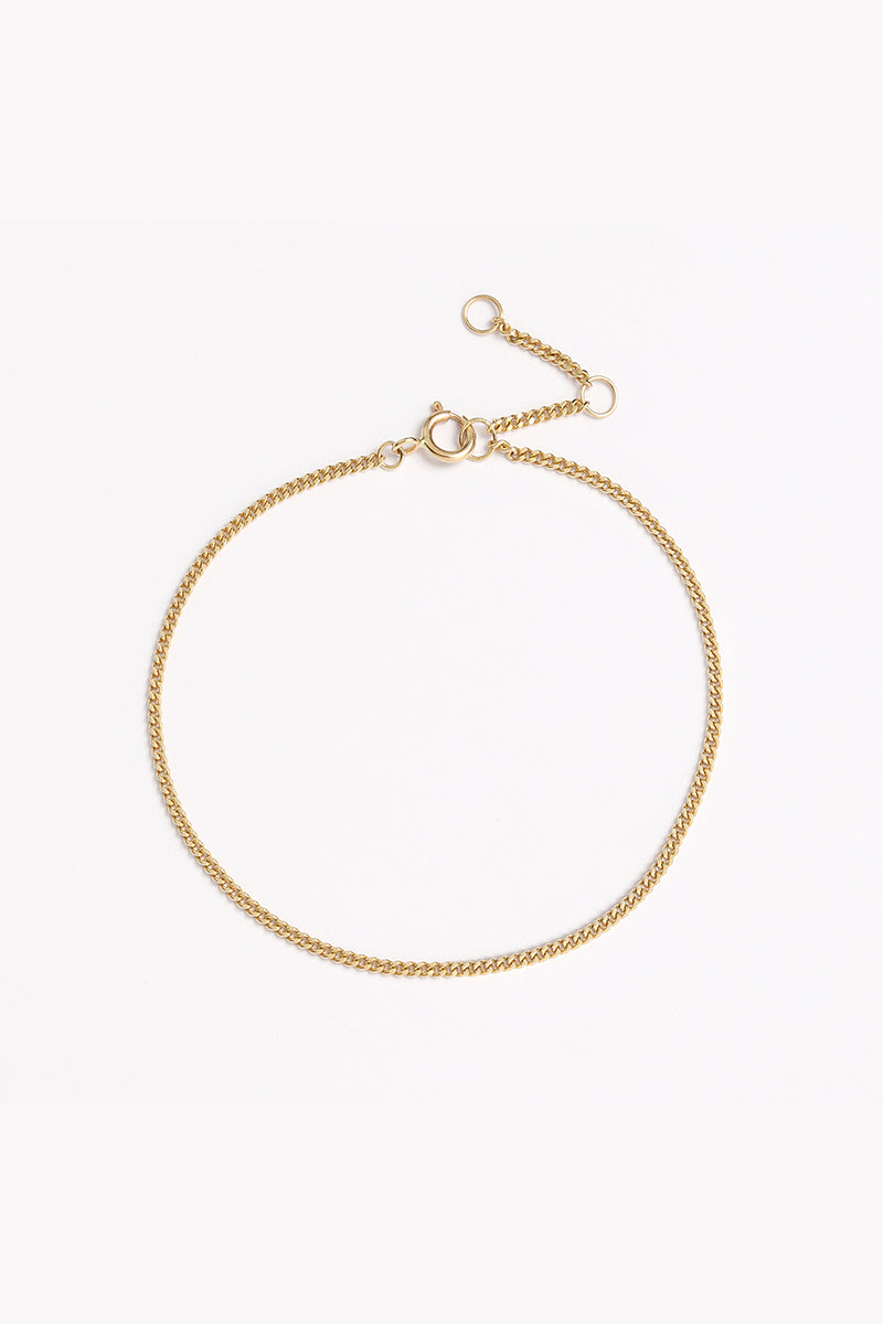 A close-up of the Solid Gold Bracelet by Bluebird Jewellery, crafted in fine gold as a personalised piece for both casual and refined occasions.