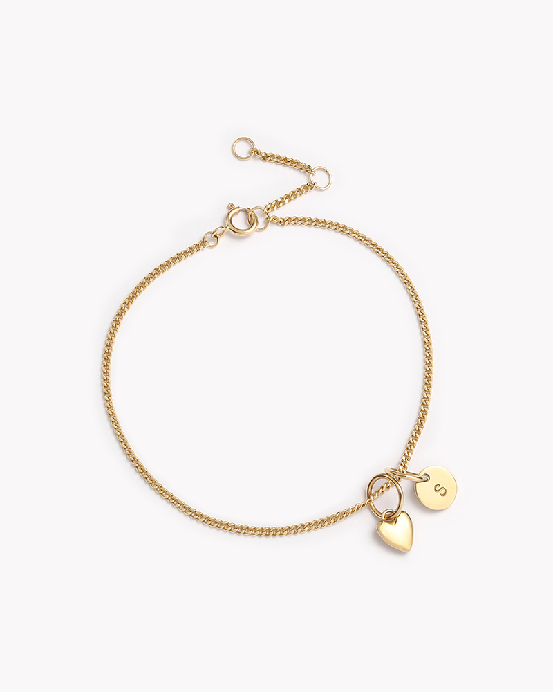 The Solid Gold Bracelet with heart and initial pendant by Bluebird Jewellery, a fine and elegant personalised bracelet designed for everyday wear and timeless sophistication.