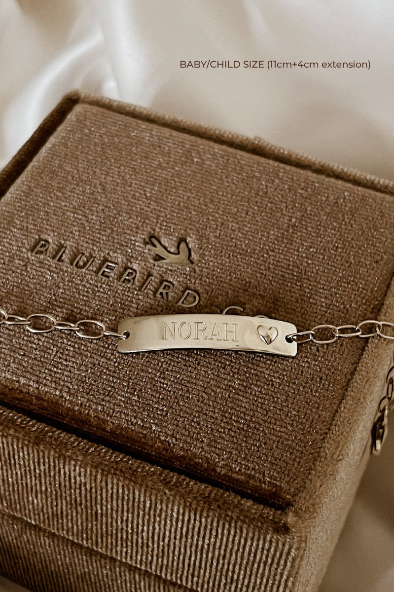Baby-size 9k Gold Darling Bracelet with heart detail and engraved plate on Bluebird Co jewellery box