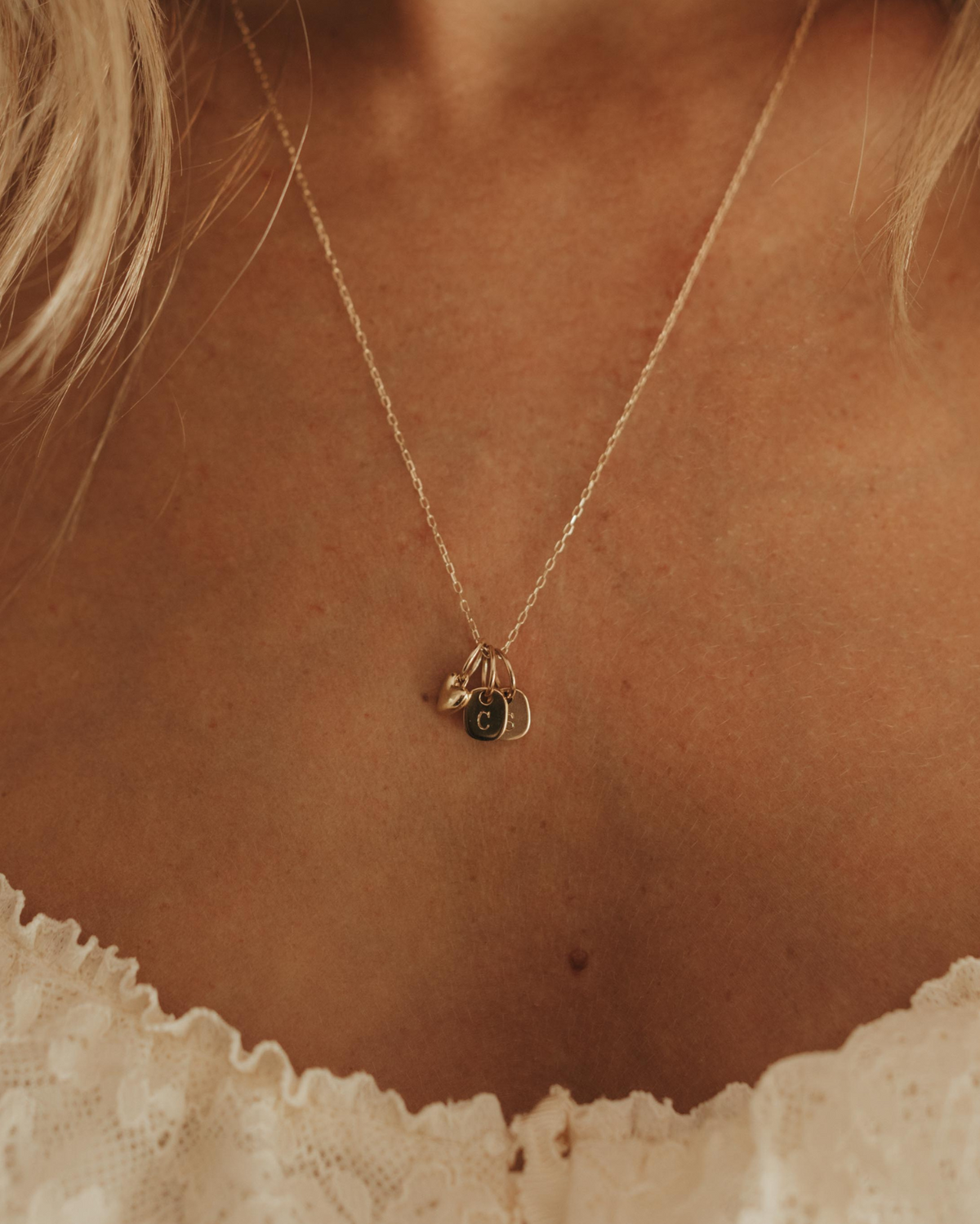 solid gold chain with mini sweetheart pendant and mini rectangular initial pendants all made from solid gold