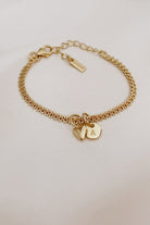 A close-up of The Lace Chain Bracelet adorned with a heart charm and personalised initial pendant, crafted as a meaningful keepsake piece.