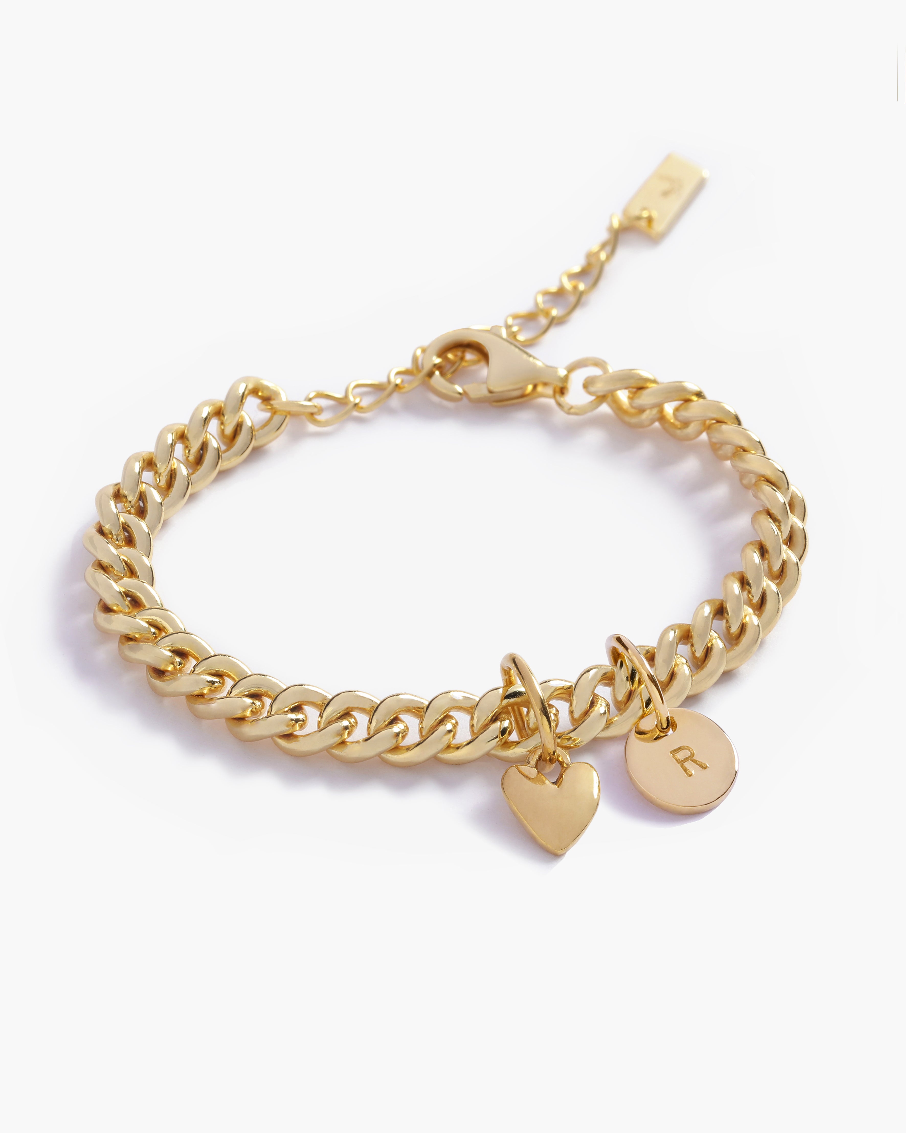 A Sweetheart Cuban Link Chain Bracelet featuring a polished heart charm and personalised soild gold initial pendant, crafted as a meaningful fine jewellery piece by Bluebird Co