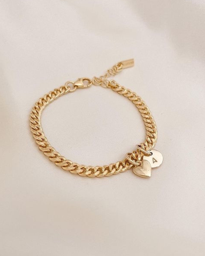 A gold chain bracelet with delicate heart charm and solid gold initial pendant for everyday wear by Bluebird Jewellery