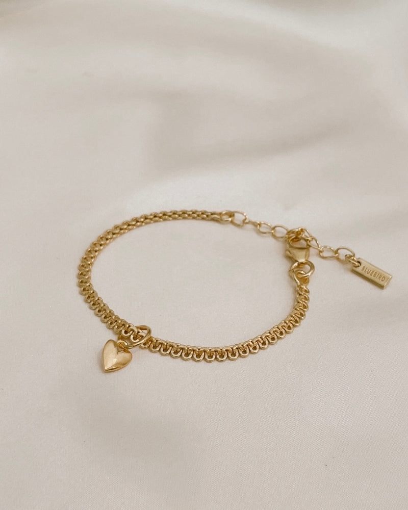 A close-up of The Lace Chain Bracelet adorned with a heart charm, crafted as a meaningful keepsake piece by Bluebird Jewellery