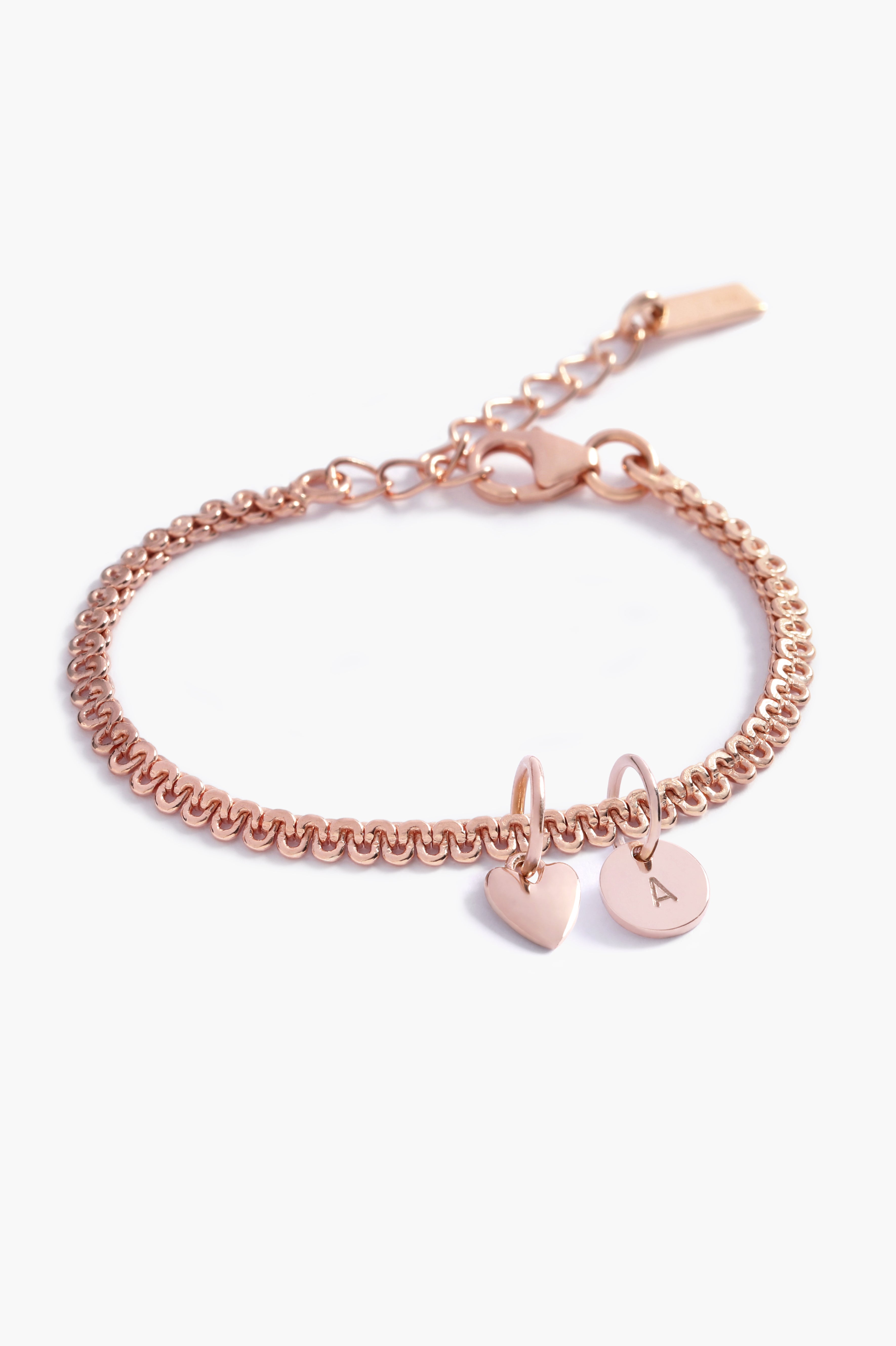 A close-up of a rose gold Lace Chain Bracelet adorned with a heart charm and personalised soild rose gold initial pendant, crafted as a meaningful keepsake piece.