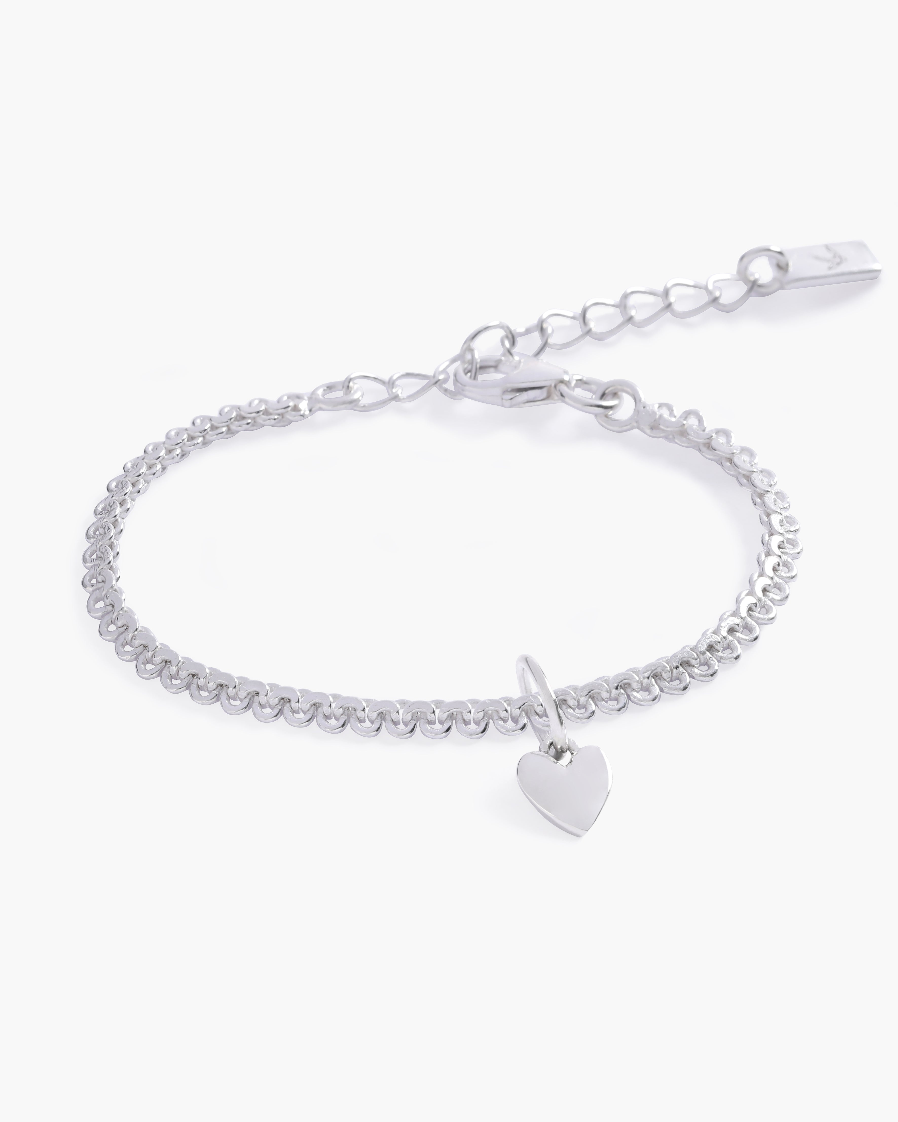 A detailed image of the silver Sweetheart Lace Chain Bracelet with a heart charm, designed with lace-inspired links for a delicate finish by Bluebird Jewellery
