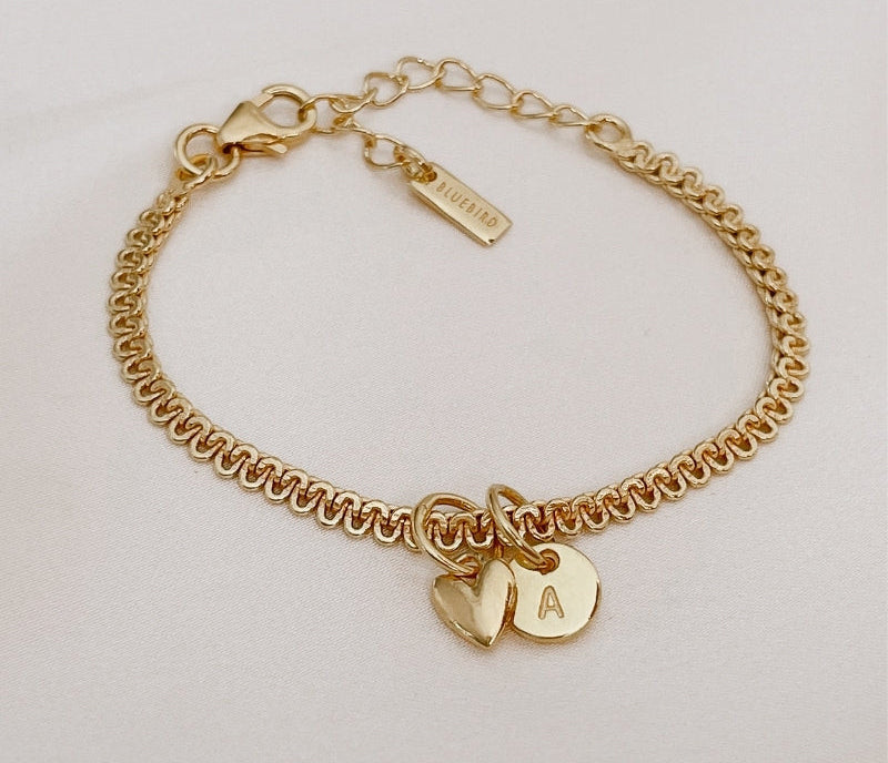 A close-up of The Lace Chain anklet adorned with a heart charm and personalised initial pendant, crafted as a meaningful keepsake piece.