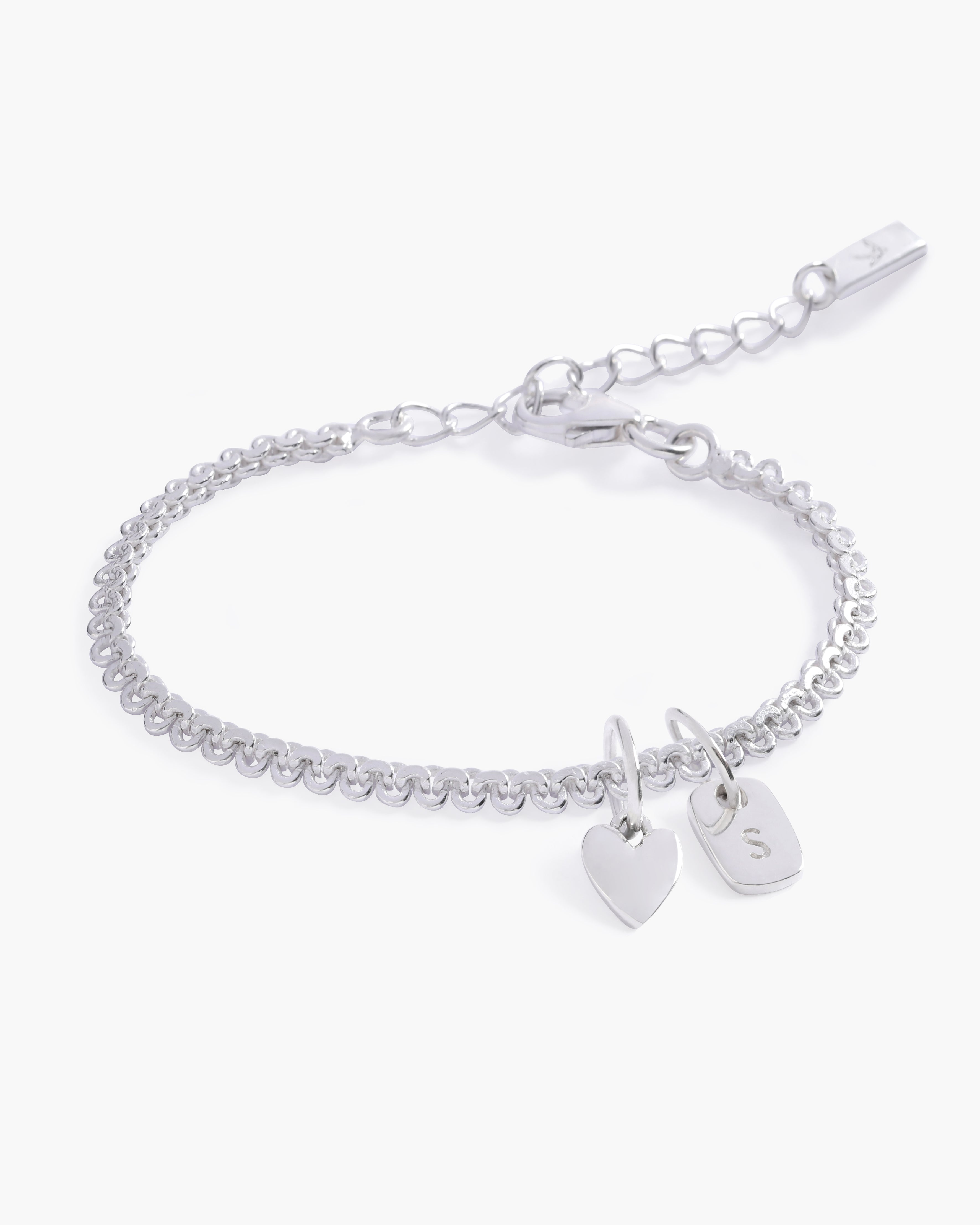 A delicate Sweetheart Lace Chain Bracelet featuring a silverheart charm and engraved rectangular letter pendant, crafted as a meaningful keepsake by Bluebird Jewellery