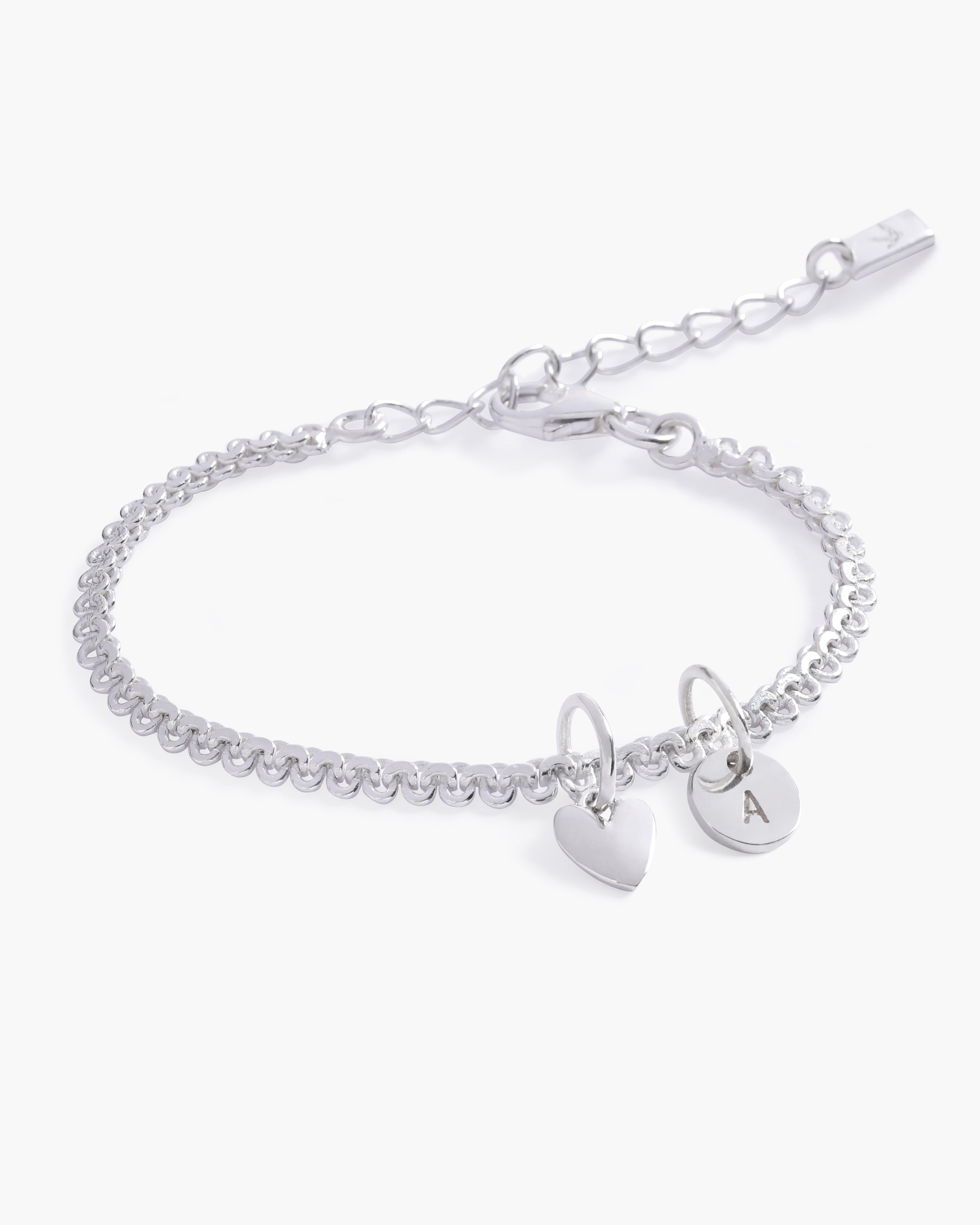 A delicate Lace Chain Bracelet with a heart charm and engraved initial pendant, designed as timeless personalised jewellery by Bluebird Co