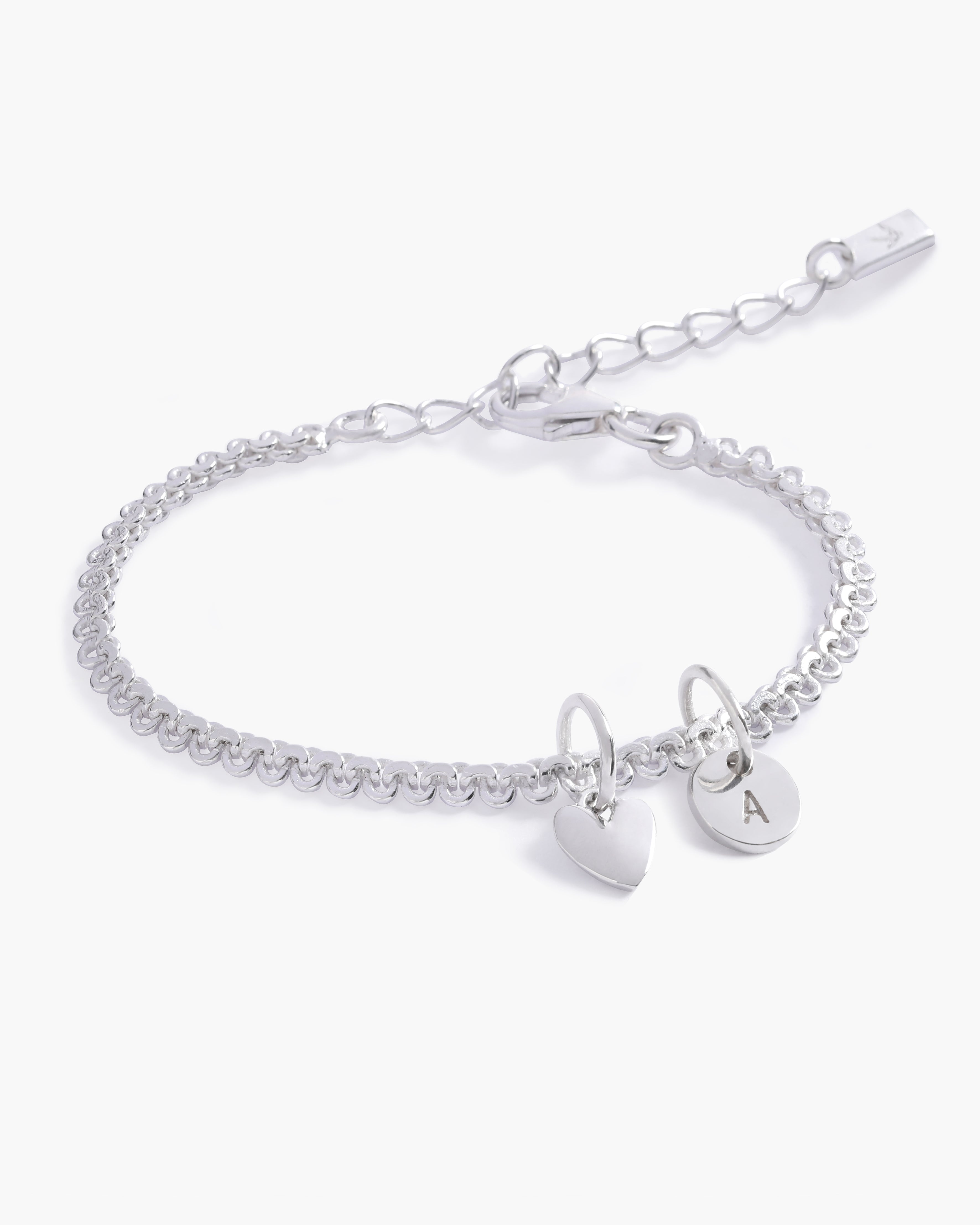 A delicate Lace Chain Bracelet with a heart charm and engraved initial pendant, designed as timeless personalised jewellery by Bluebird Co