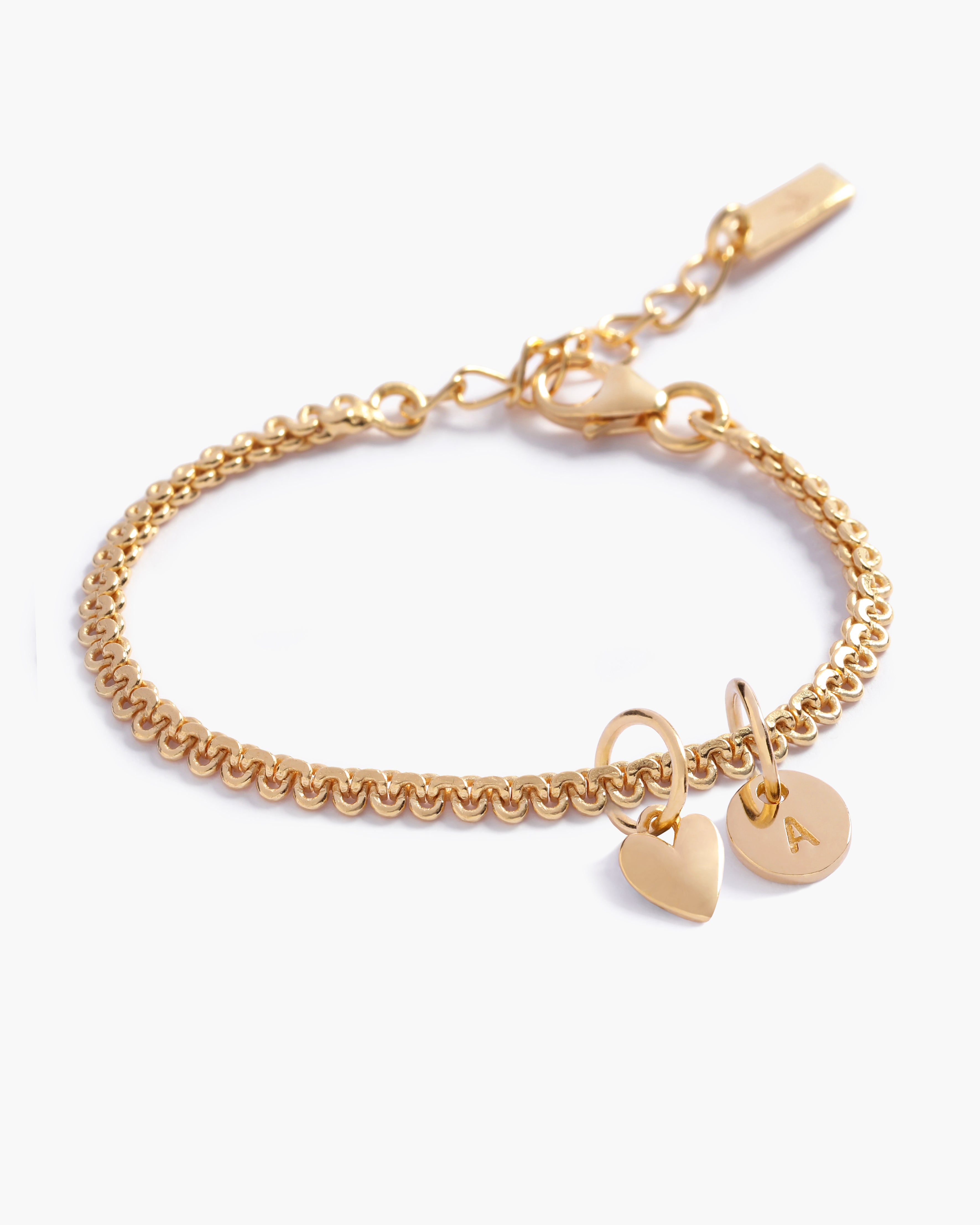 A personalised Lace Chain Bracelet featuring a heart charm and initial pendant, designed as an elegant fine jewellery gift for all ages by Bluebird Co