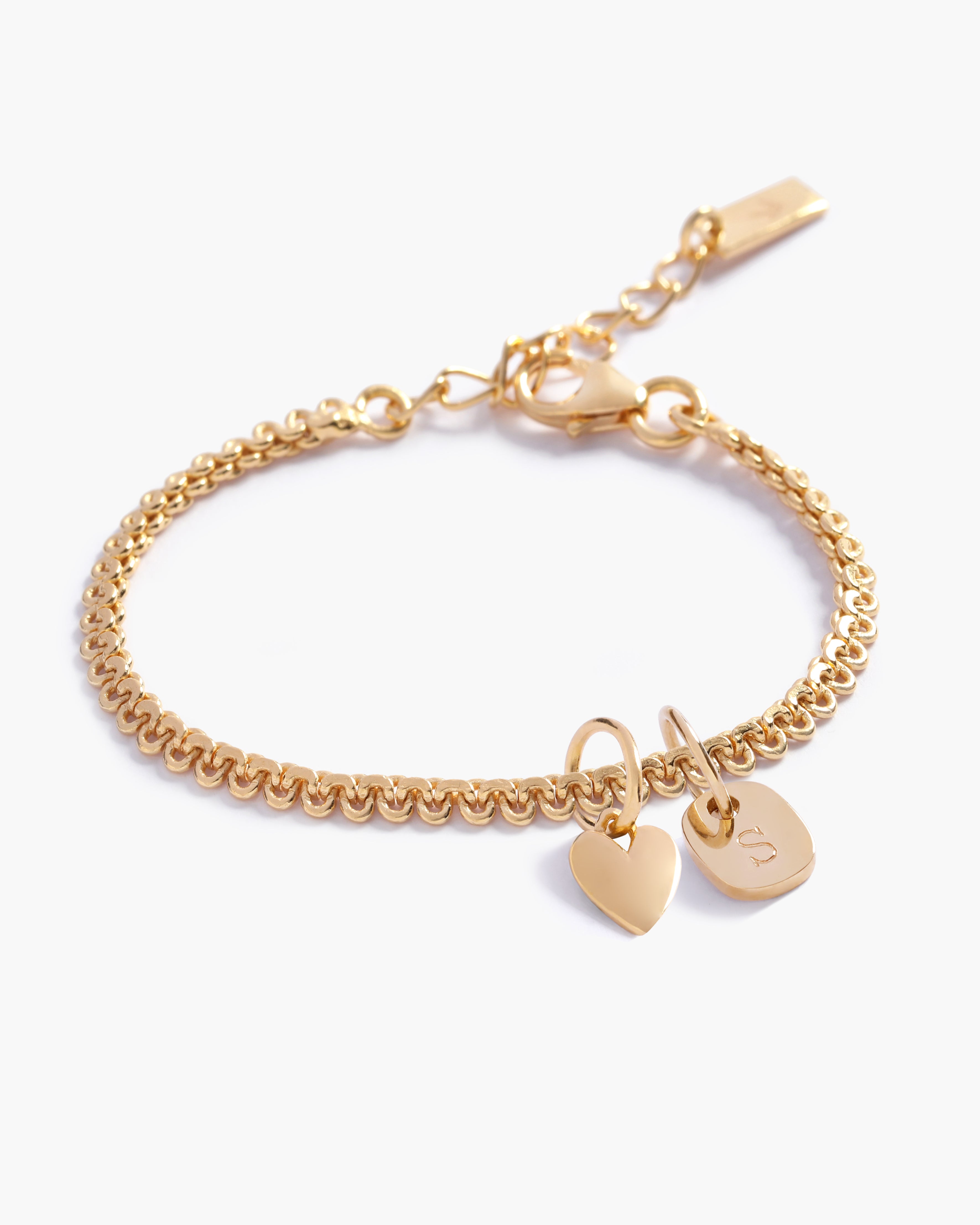A personalised Lace Chain Bracelet featuring a heart charm and soild gold mini rectangular initial pendant, designed as an elegant fine jewellery gift for all ages by Bluebird Co