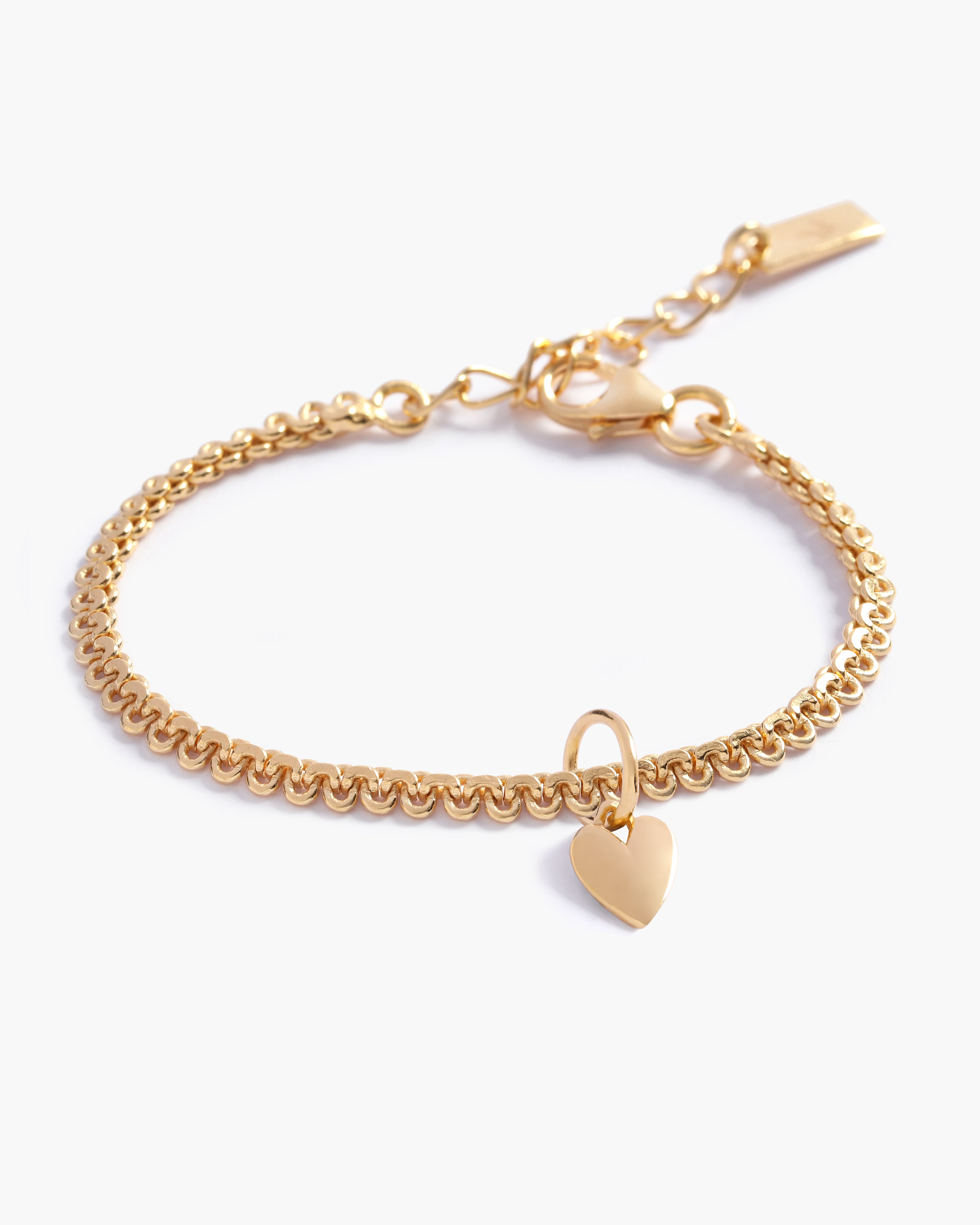 A close-up of The Lace Chain Anklet with a heart charm, an elegant gold chain with delicate lace-like detailing, and a refined minimalist design by Bluebird Jewellery