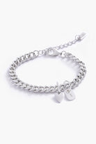 A detailed image of a silver Sweetheart Cuban Link Chain Bracelet with a heart charm and engraved initial pendant, designed as elegant personalised jewellery.