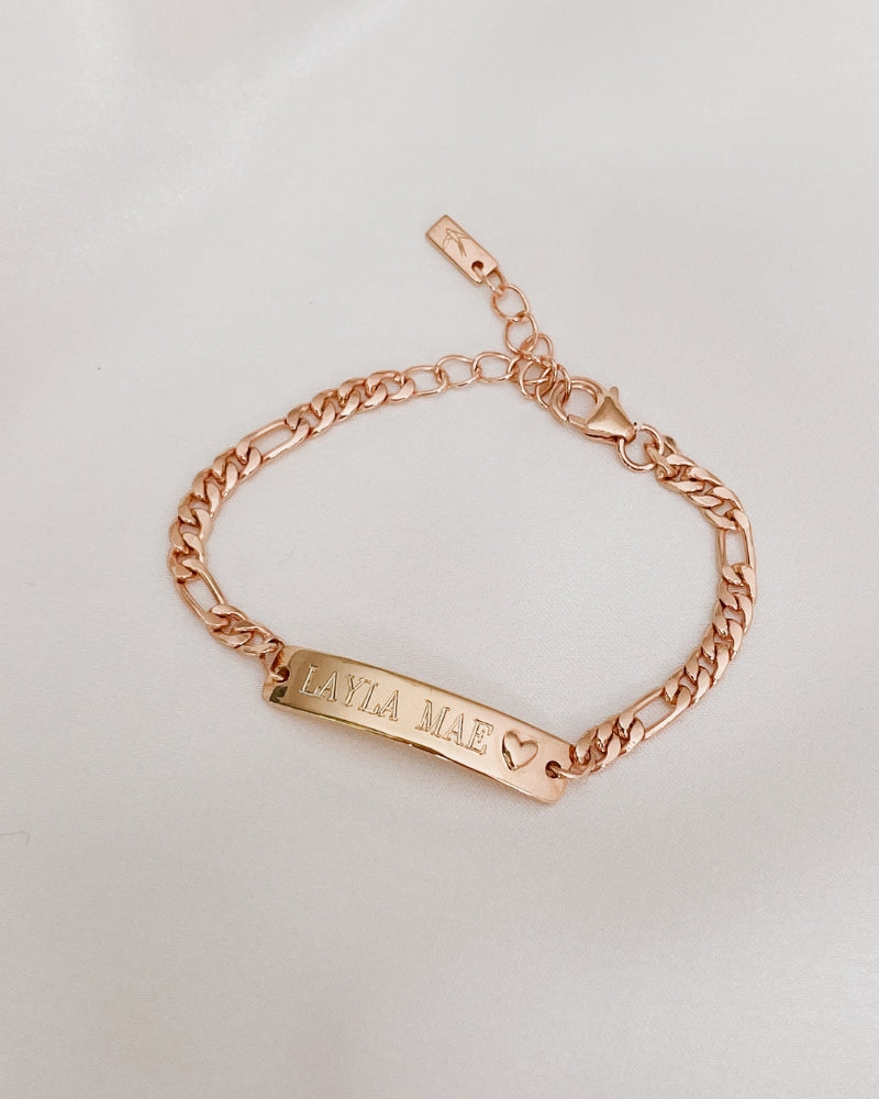 Engraved Darling Rose Gold Bracelet for children featuring a solid heart charm on the ID plate by Bluebird Jewellery.