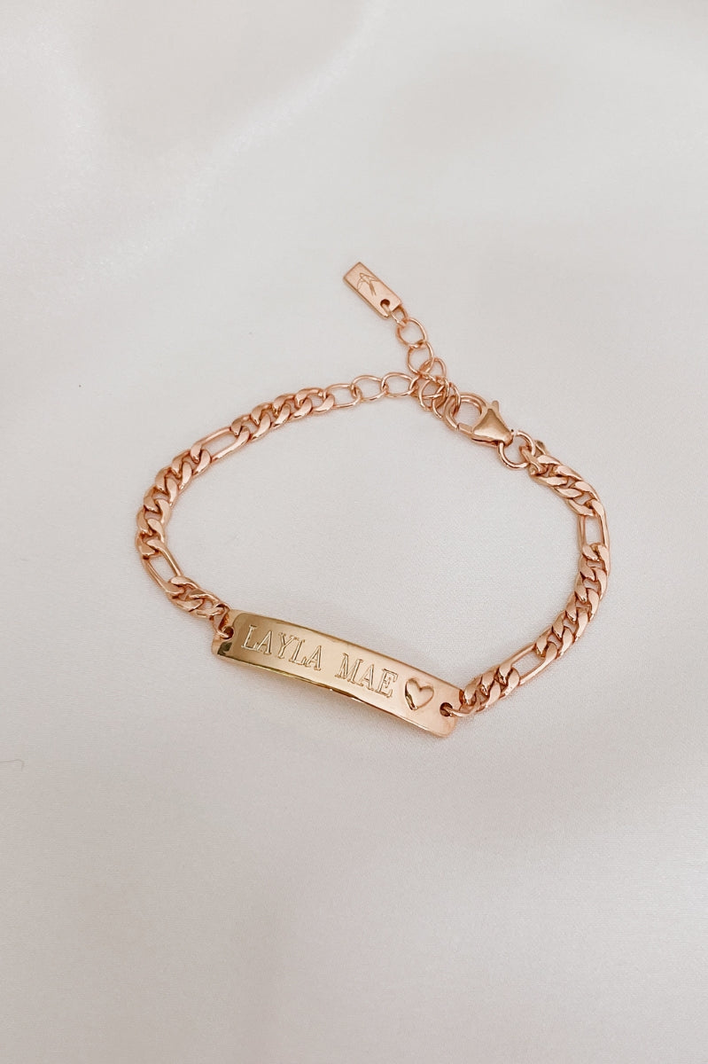Engraved Darling Rose Gold Bracelet for children featuring a solid heart charm on the ID plate by Bluebird Jewellery.