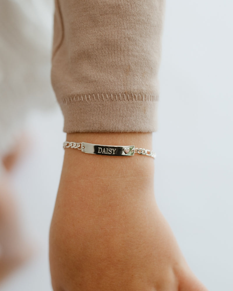 Child wearing engraved Pink Darling Silver Bracelet with pink heart—made for birthdays, keepsakes, or special occasions by Bluebird Jewellery.