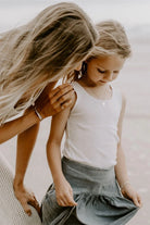 Silver personalised necklace worn by daughter, capturing the love and connection between mother and child.