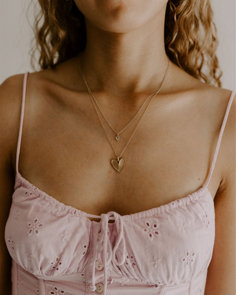Petite Darling Necklace worn as a layered keepsake piece with heart detail.