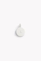 Single round silver pendant engraved with the letter L, from the Petite Signature Necklace Silver collection on white backdrop.