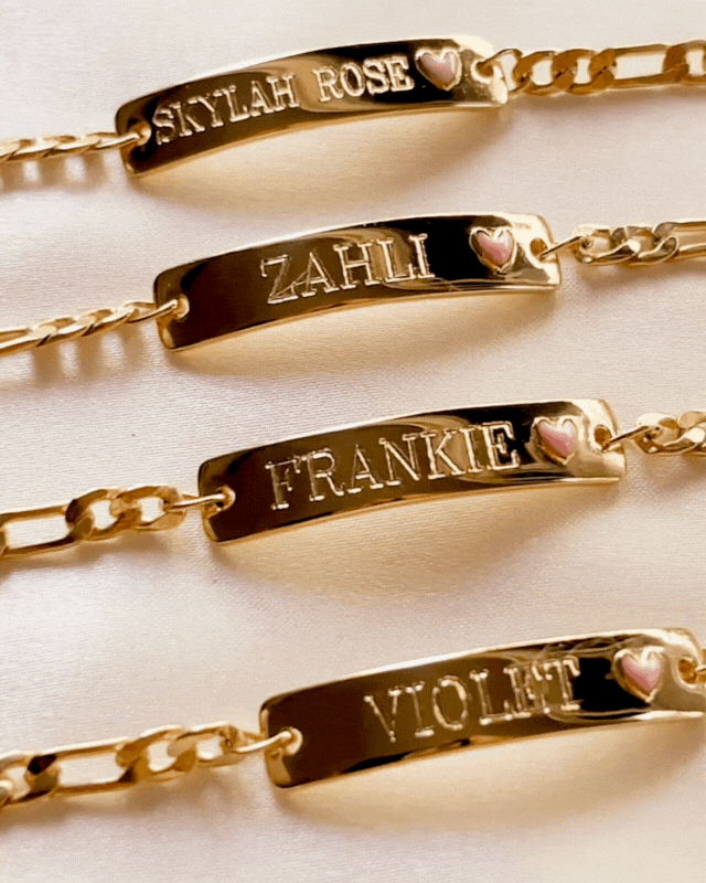 Row of Pink Darling Gold name bracelets with pink hearts—personalised jewellery for siblings, cousins, or best friends by Bluebird Jewellery