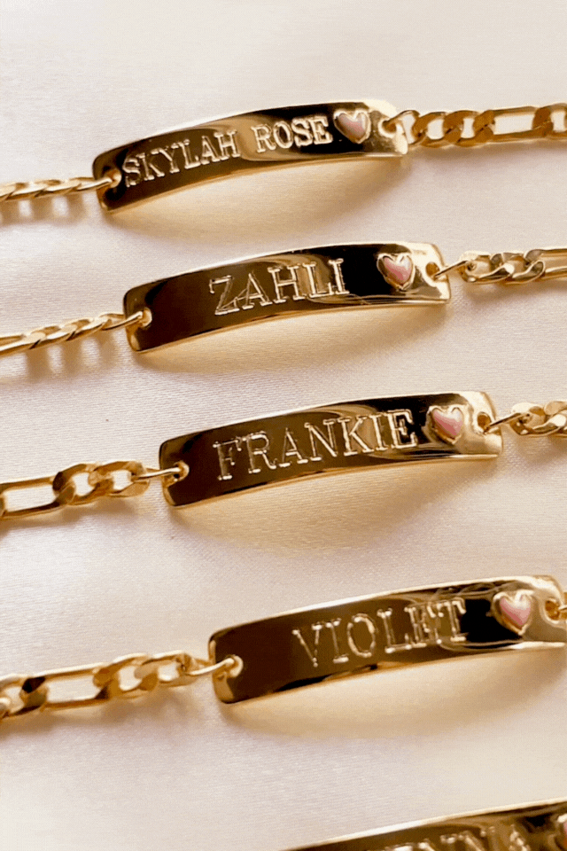 Row of Pink Darling Gold name bracelets with pink hearts—personalised jewellery for siblings, cousins, or best friends by Bluebird Jewellery