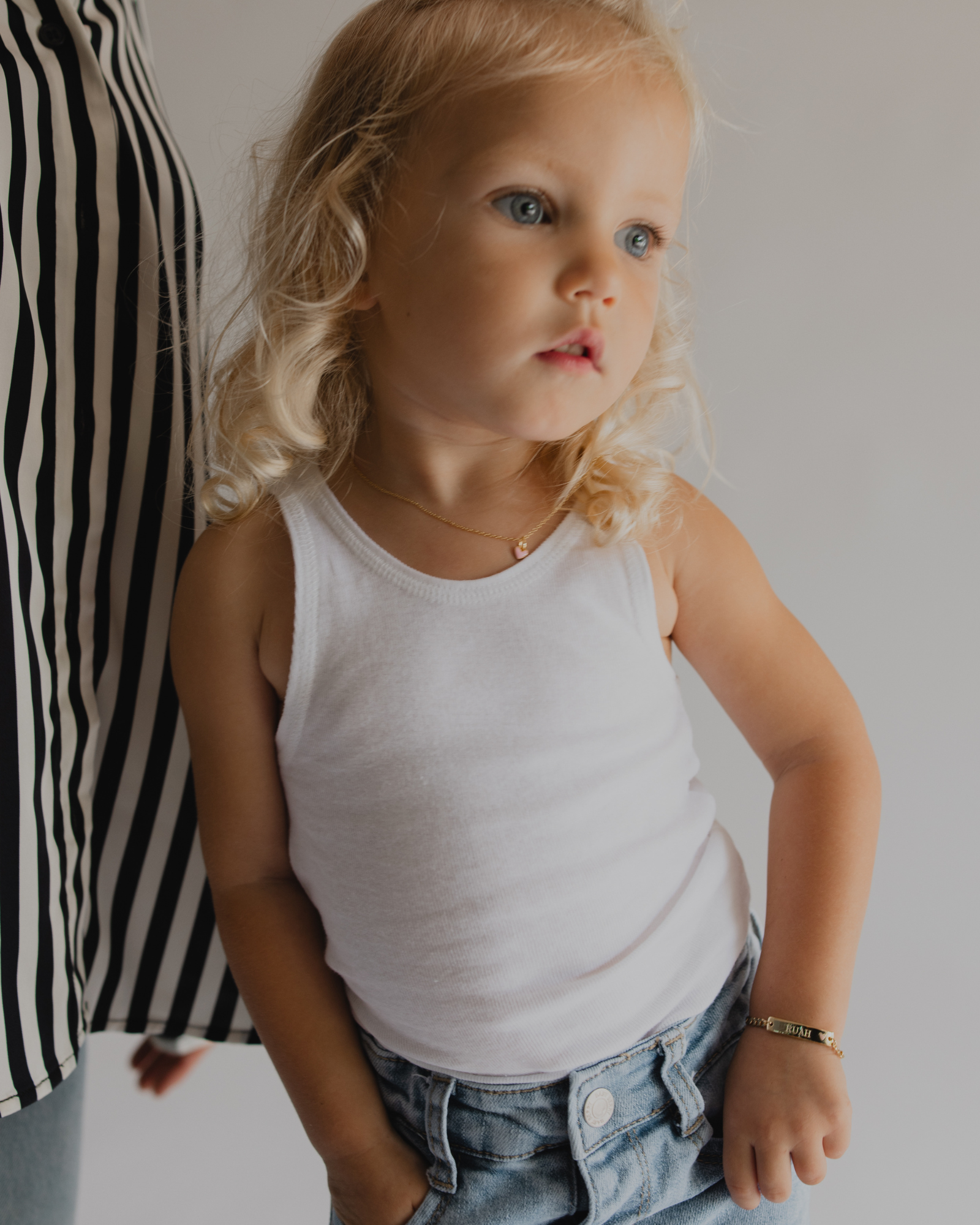 Toddler wearing Pink Darling Gold engraved bracelet and necklace—personalised jewellery gift for daughters or nieces by Bluebird Jewellery.