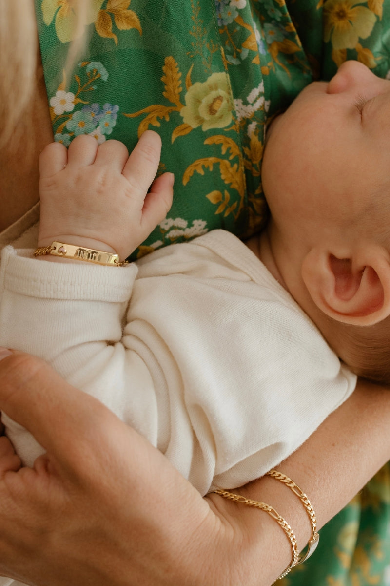 Baby wearing Pink Darling Gold bracelet—engraved jewellery for newborn, memory-making, and love by Bluebird Jewellery.