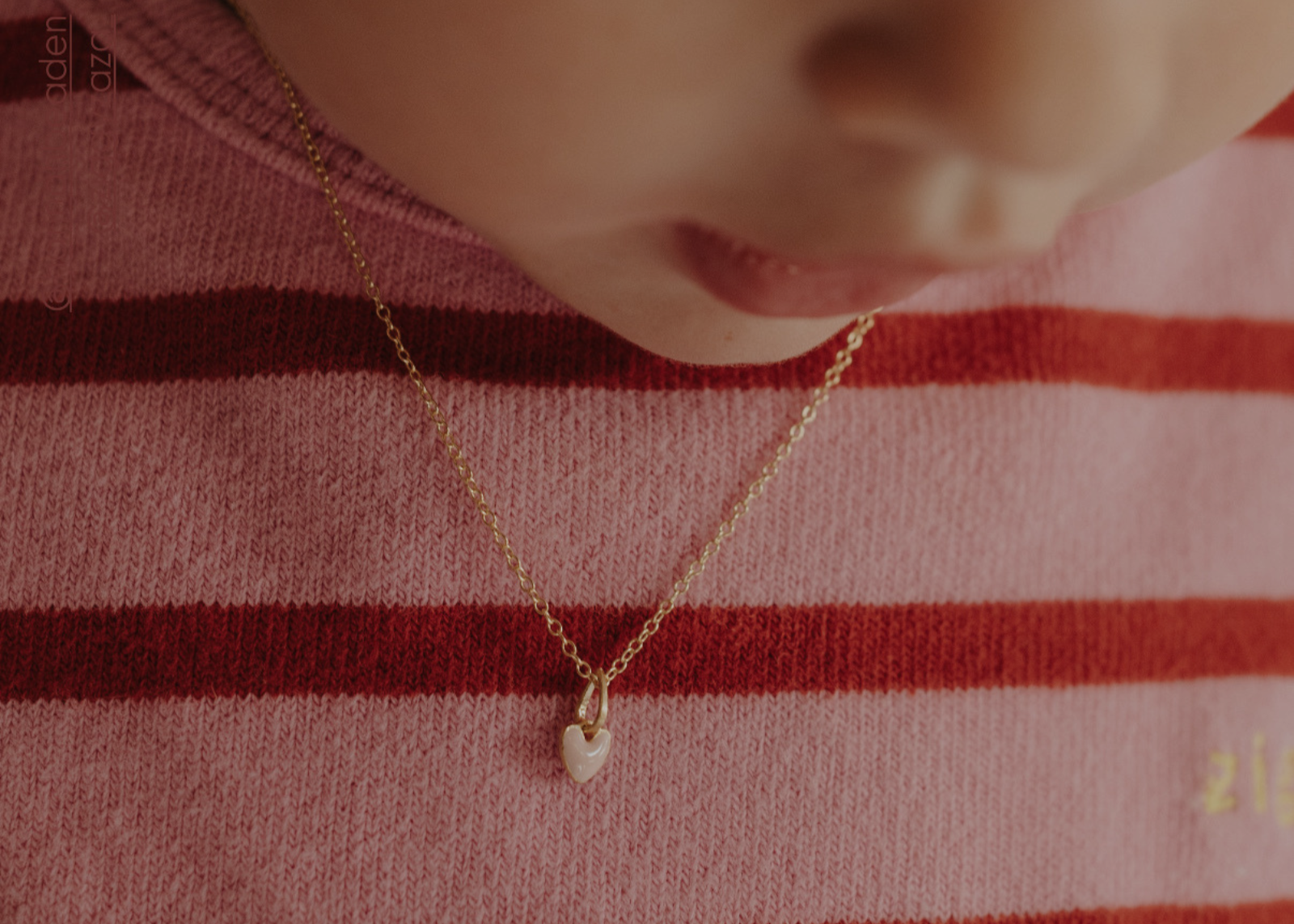 Pink Petite Darling gold necklace worn by child with pink heart pendant
