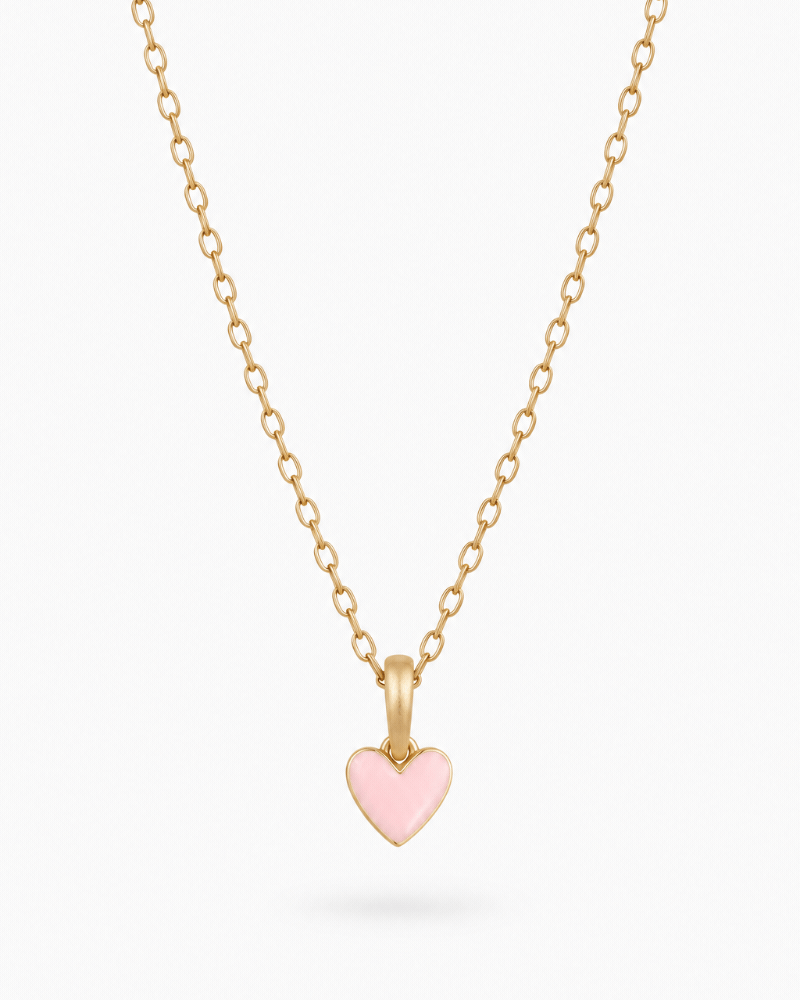 A petite necklace designed for children and adults that features a soft pink heart pendant alongside optional initial pendant/s