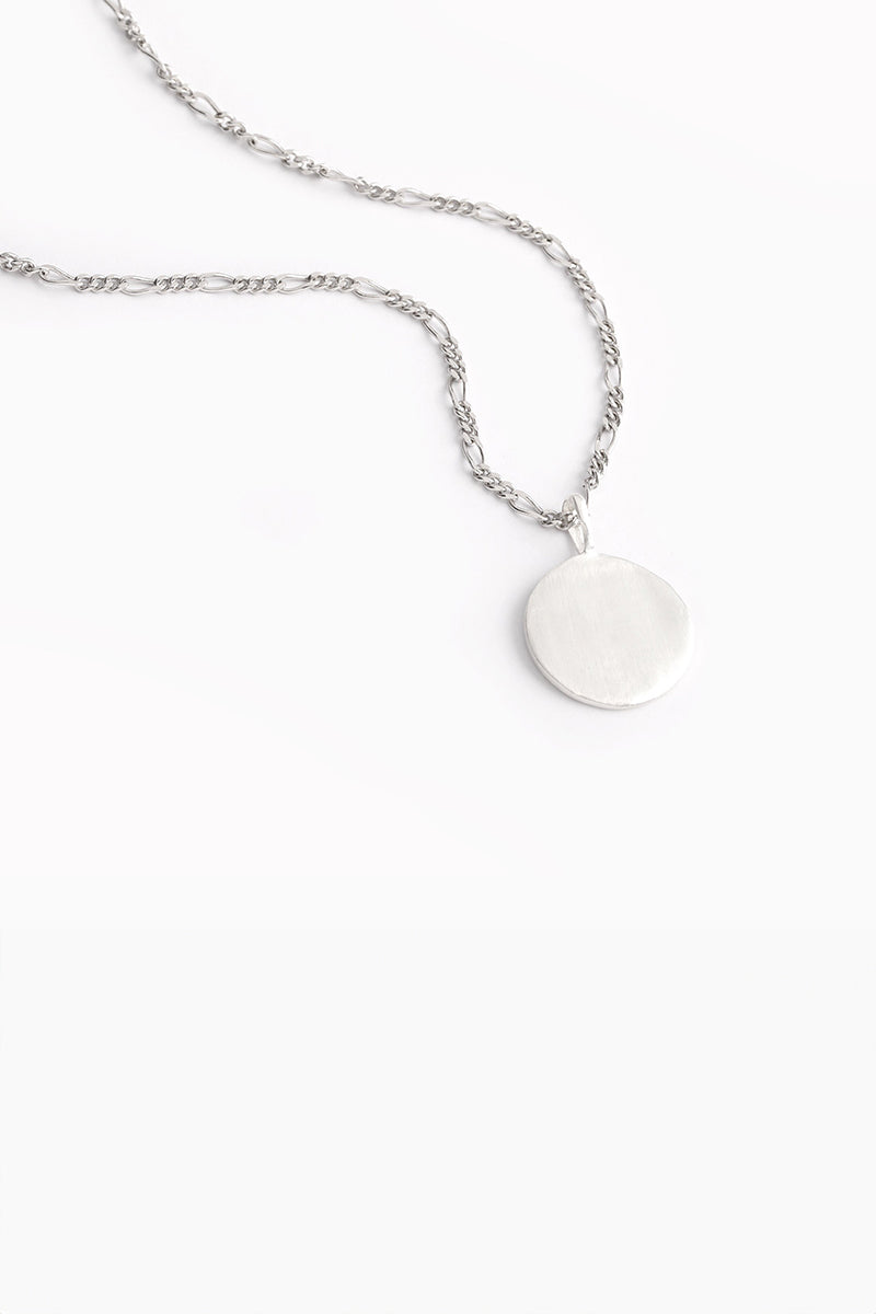 Plain silver round pendant necklace with textured finish.
