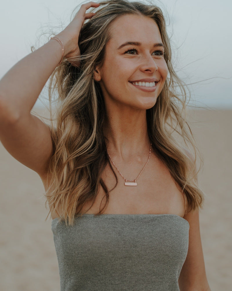 Rose gold Signature Bar Necklace styled on model. Personalised engraved jewellery perfect for everyday wear.