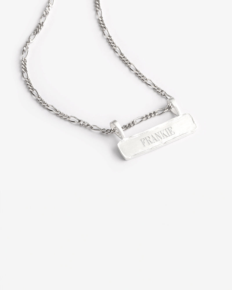 Signature Bar Necklace Silver engraved with “FRANKIE” displayed on a clean white background. A minimal and elegant silver name necklace.