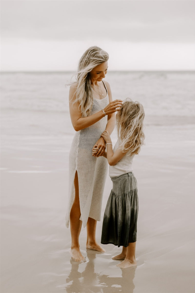 Mother and daughter at beach wearing matching engraved silver bracelets by Bluebird Jewellery.