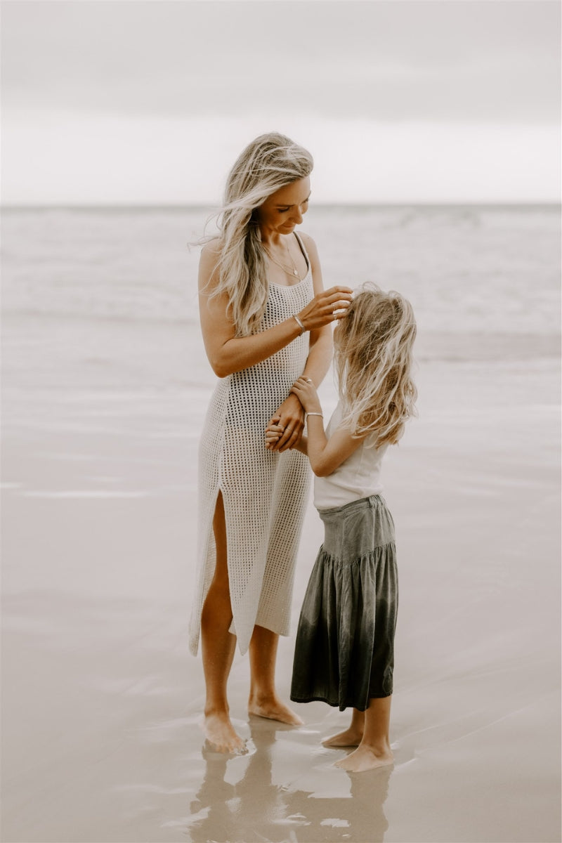 Mother and daughter at beach wearing matching engraved silver bracelets by Bluebird Jewellery.