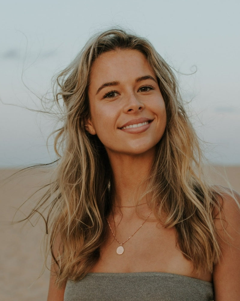 Model wearing engraved rose gold pendant necklace as a single statement piece