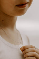 Personalised silver disc necklace representing family bonds, worn by daughter and cherished by mum.