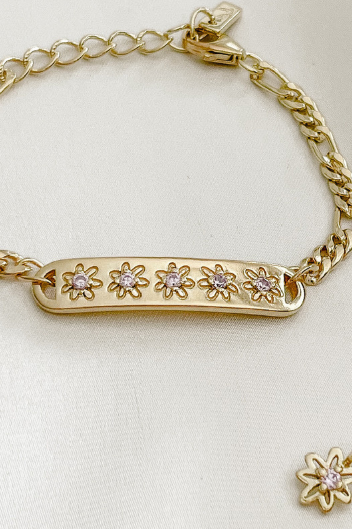 The Daisy Bracelet by Bluebird Jewellery, featuring five hand-drawn daisies with pink cubic zirconia centres, crafted as a feminine and floral fine jewellery piece.