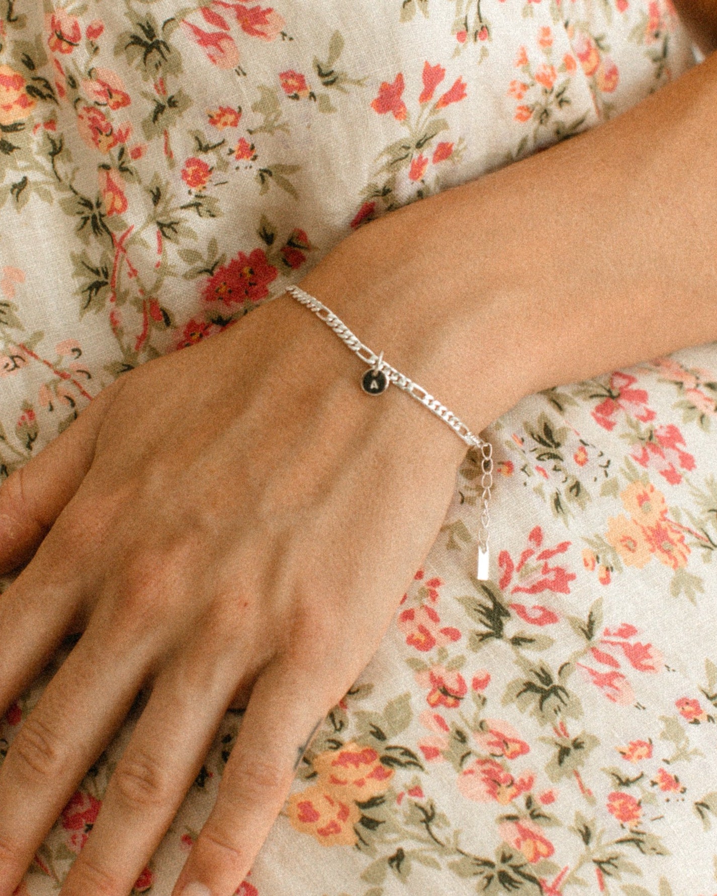 A Figaro Bracelet in adult length worn with one 6mm initial pendant by Bluebird Jewellery