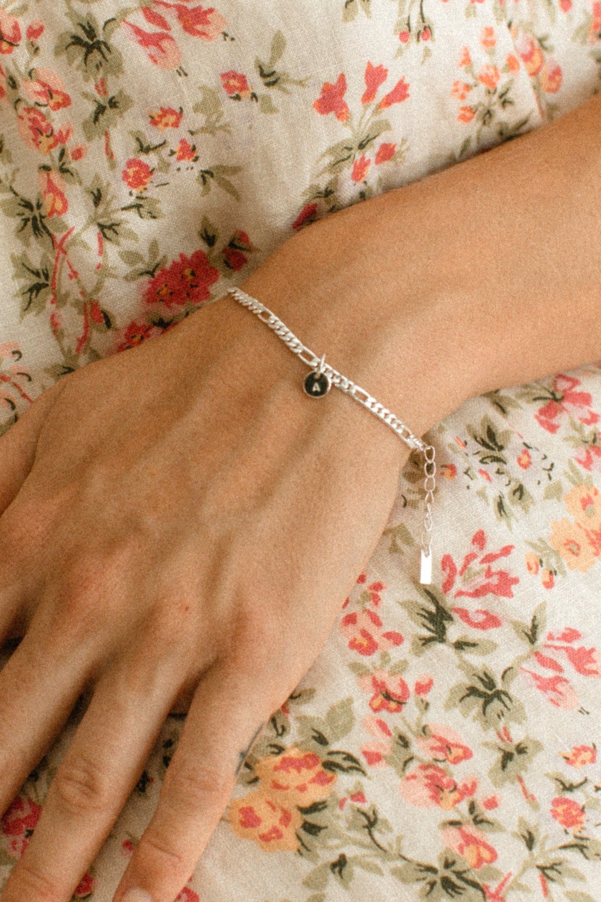 A Figaro Bracelet in adult length worn with one 6mm initial pendant by Bluebird Jewellery