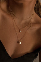 Model wears Ball Chain Necklace, Vintage Pearl Necklace and Ball Chain Necklace with Initial Pendant.