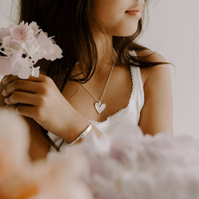 A young girl wears the Darling in necklace in 35+5cm length and it is paired with the Pink Darling Bracelet in child length