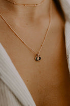 A close up side profile of the Rose Gold Petite Personalised necklace sitting elegantly on a woman's décolletage. The necklace is woern at a 45cm mid length with a shorter, 35cm length, Rose Gold Ball Chain necklace layered with it.